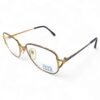 Angled side view of Charmant Lite Titanium women's square eyeglasses with grey frame and gold bridge.