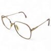 Angled view showcasing the 22kt gold Zeiss frames with red highlights and crystal embellishments.