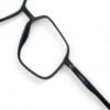 Close-up of the Dunhill branding on the temple of the matte black carbon fiber eyeglasses - emphasizing the luxury and quality of the brand